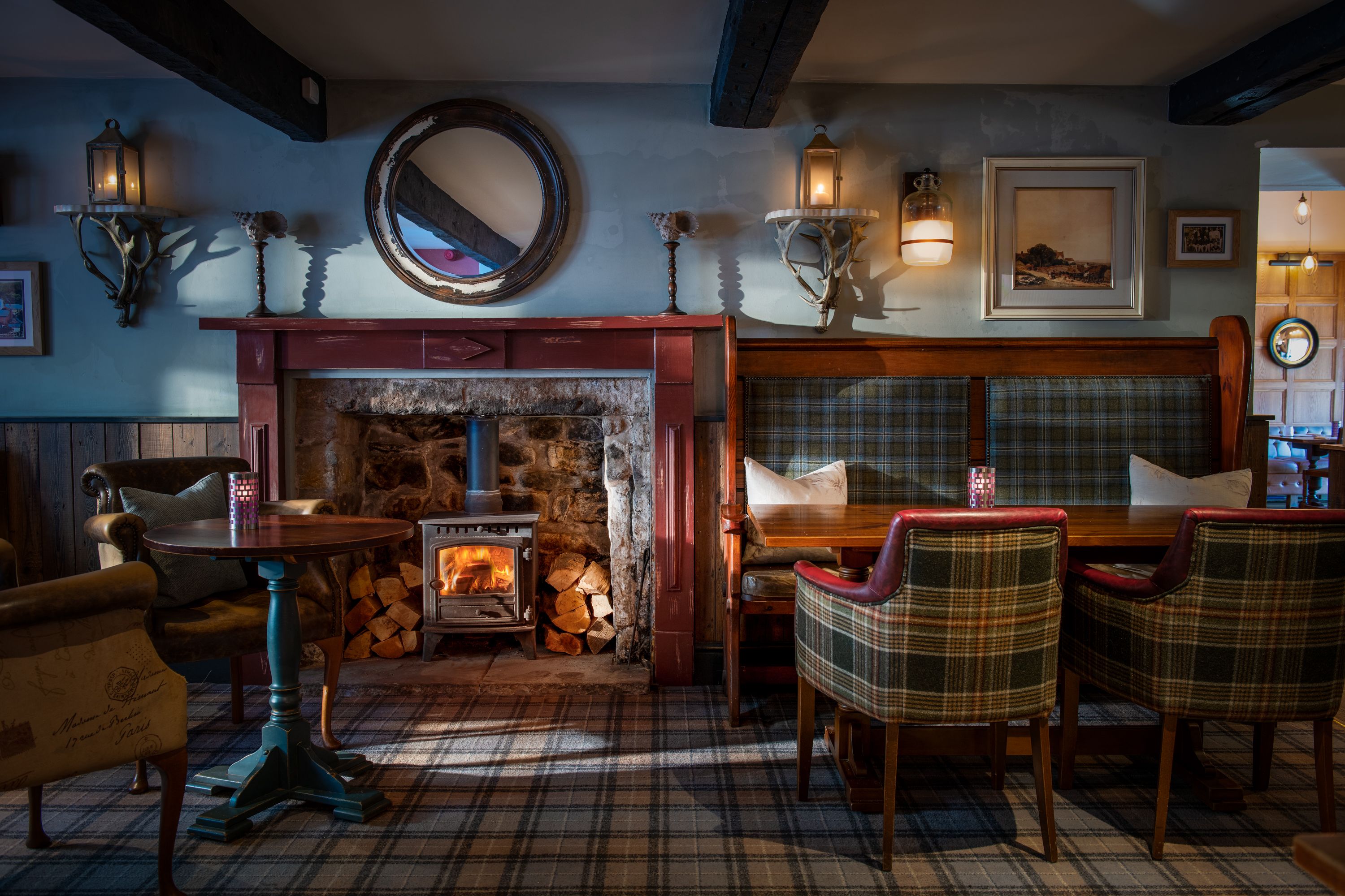 a log burner in the bar area with comfy chairs