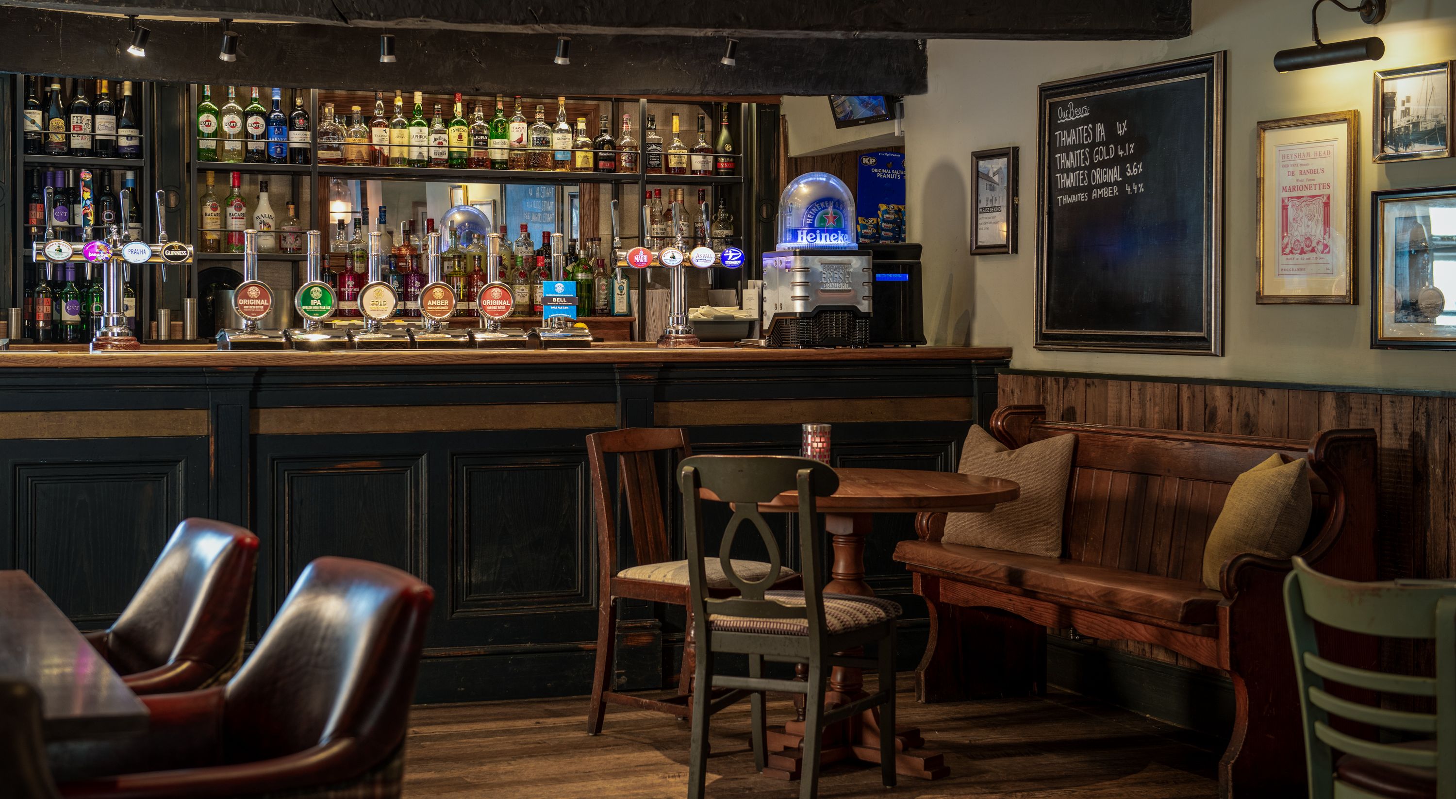 a bar with thwaites ales and wooden benches