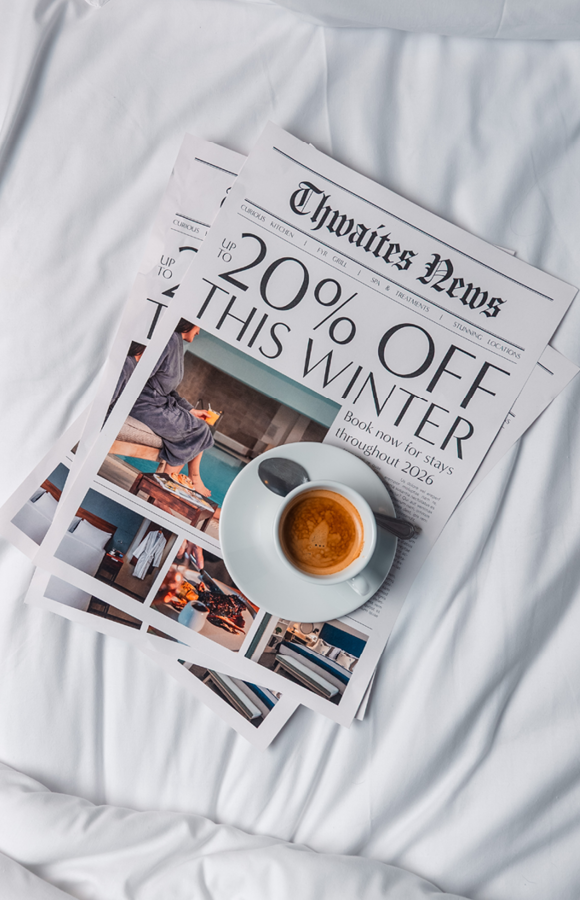 "up to 20% off this winter" newspaper with coffee on hotel bed